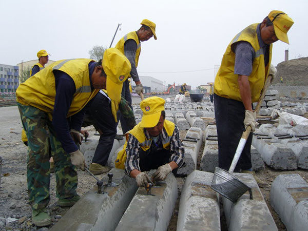 nailing the screw spike into the center of the hole